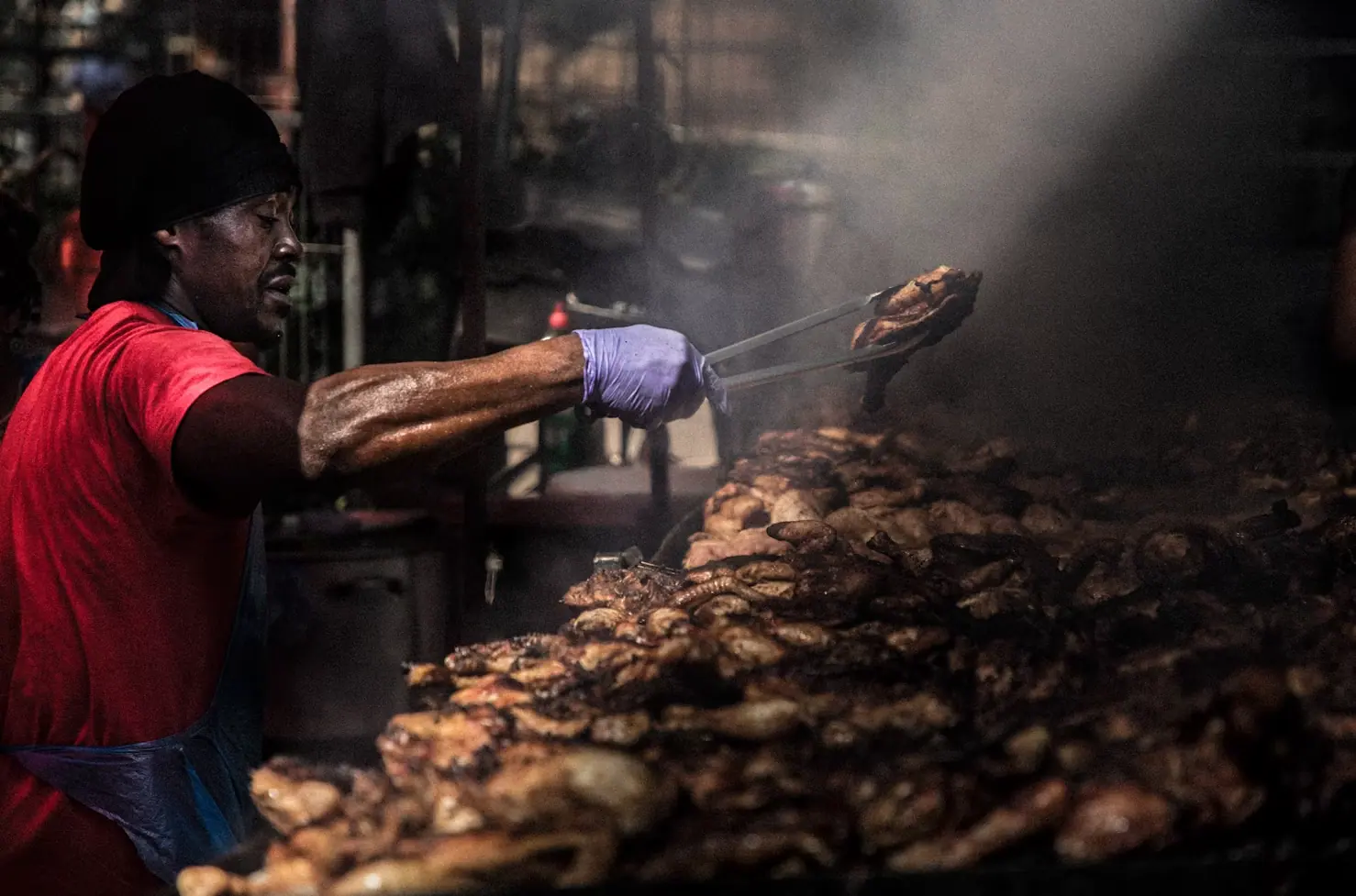 Chef tending the jerk pan at Riddim Kitchen, Walthamstow